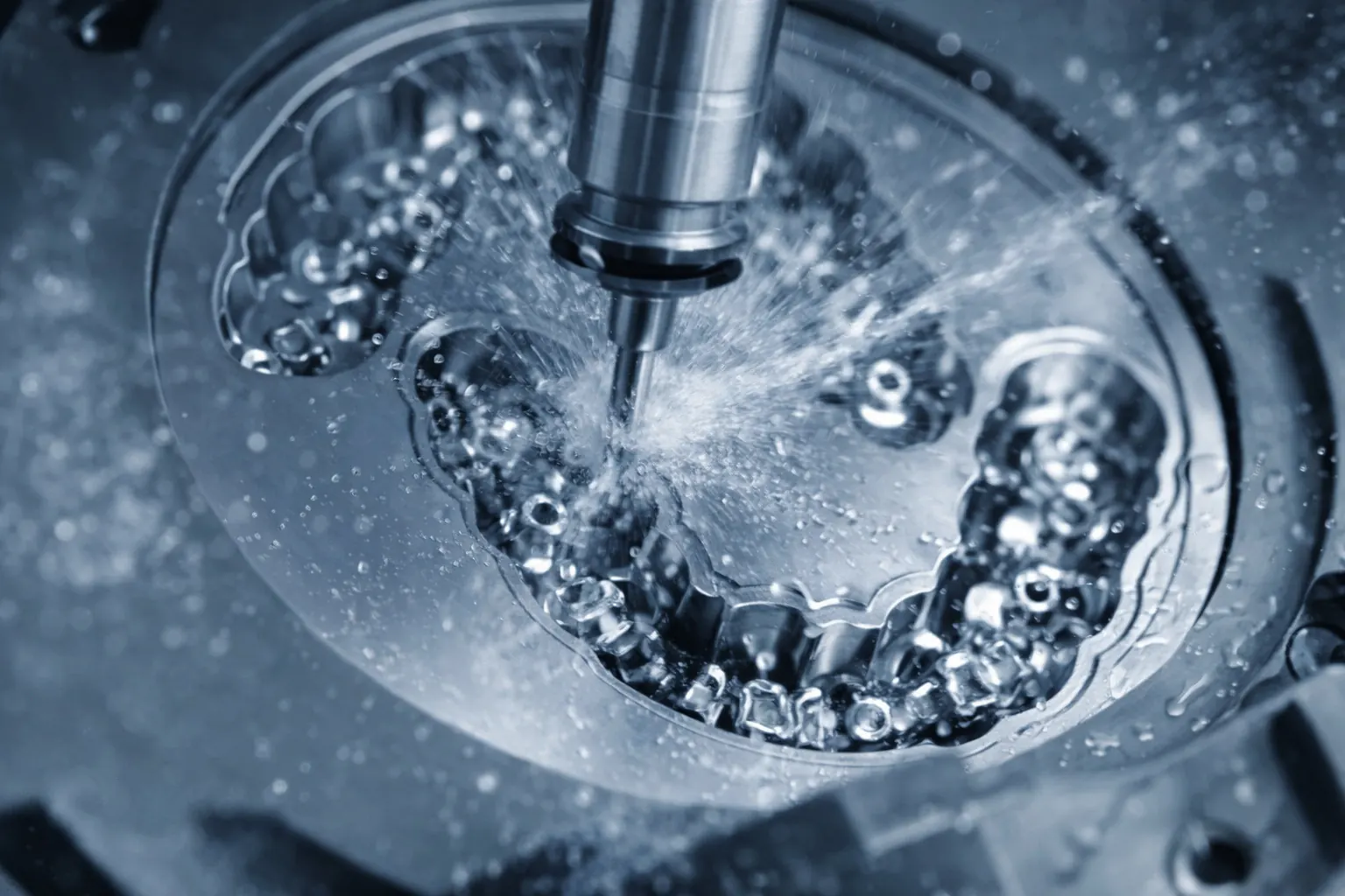 Milling bur cutting a dental restoration from a disc